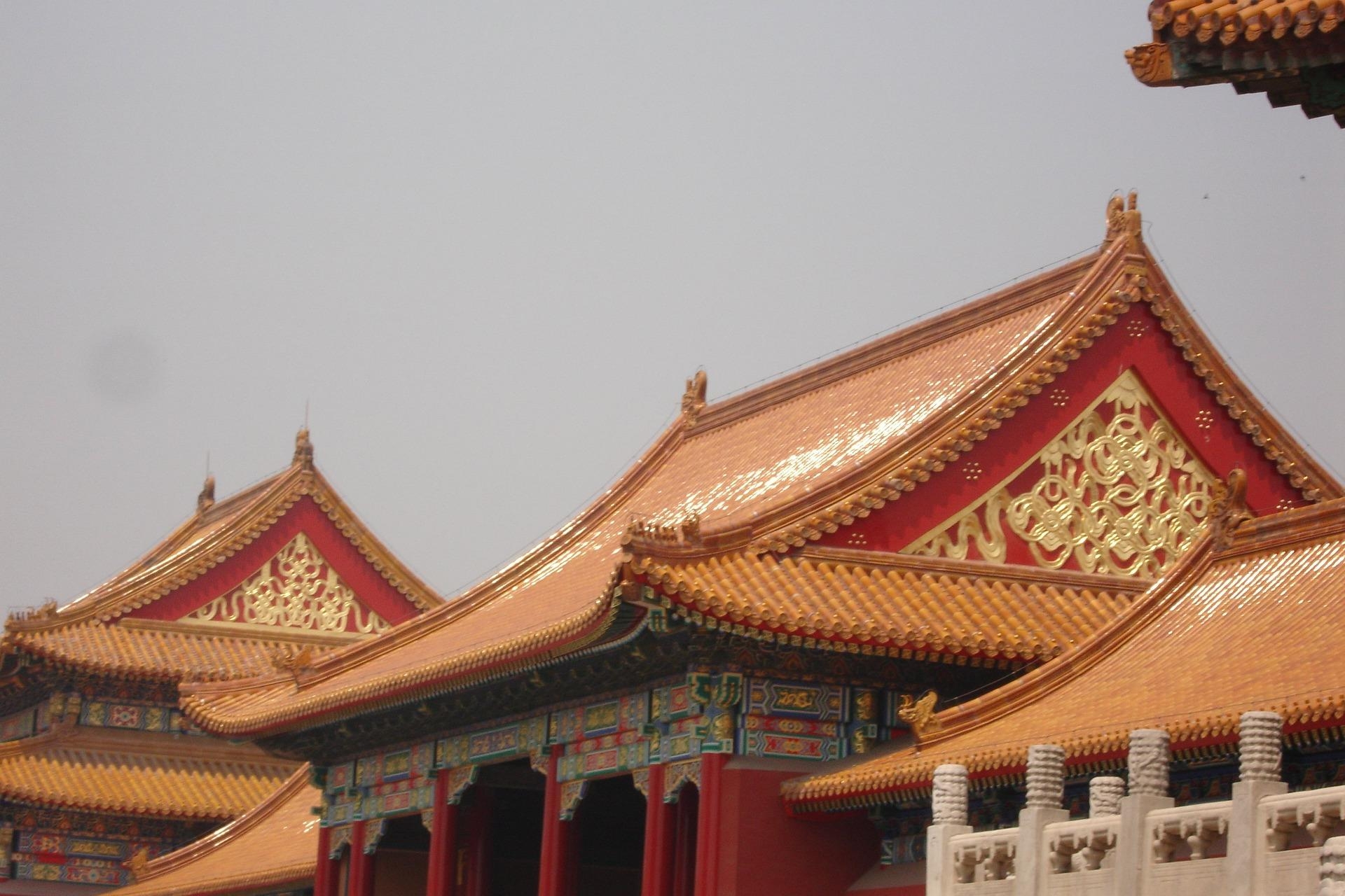 Golden rooftops and ornate red walls of Forbidden City palace buildings in Beijing