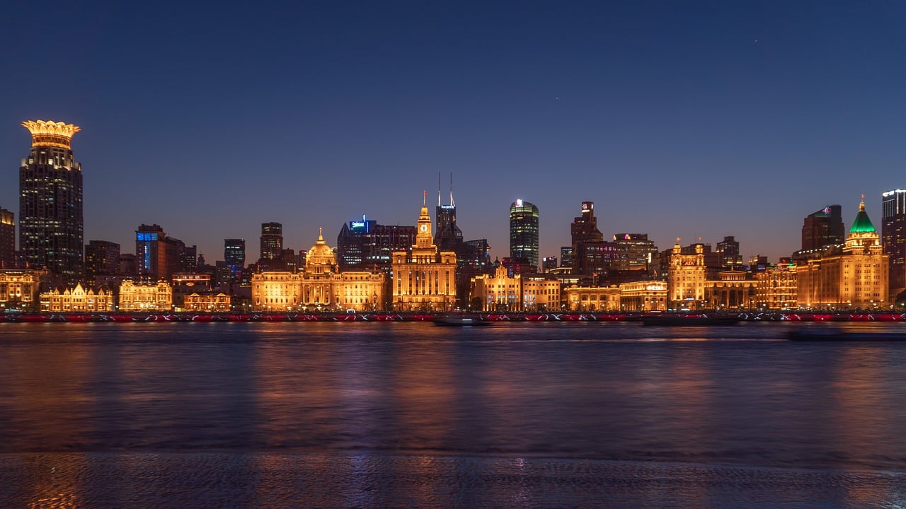 Best Private China Tours view of Shanghai Bund skyline illuminated at night along Huangpu River