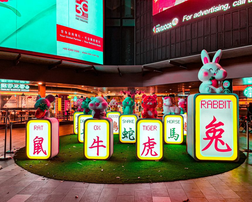 Colorful Chinese zodiac animal statues on illuminated blocks in a Singapore street display. Title: Chinese Zodiac Display Singapore