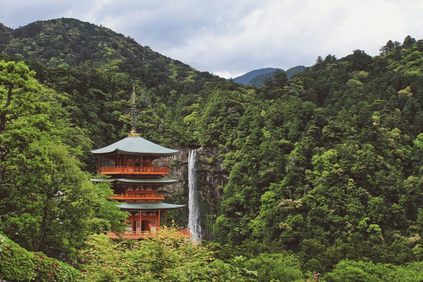 Traditional Japanese pagoda near Nachi Falls, nestled in lush green mountains of Wakayama, Japan.