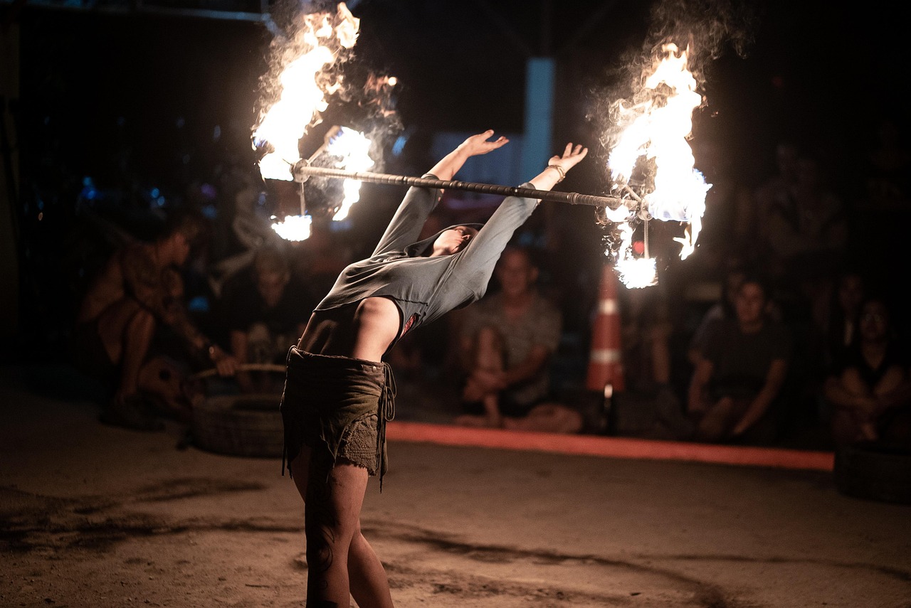 Fire dancer performing in Thailand (Image by mxwegele from Pixabay)